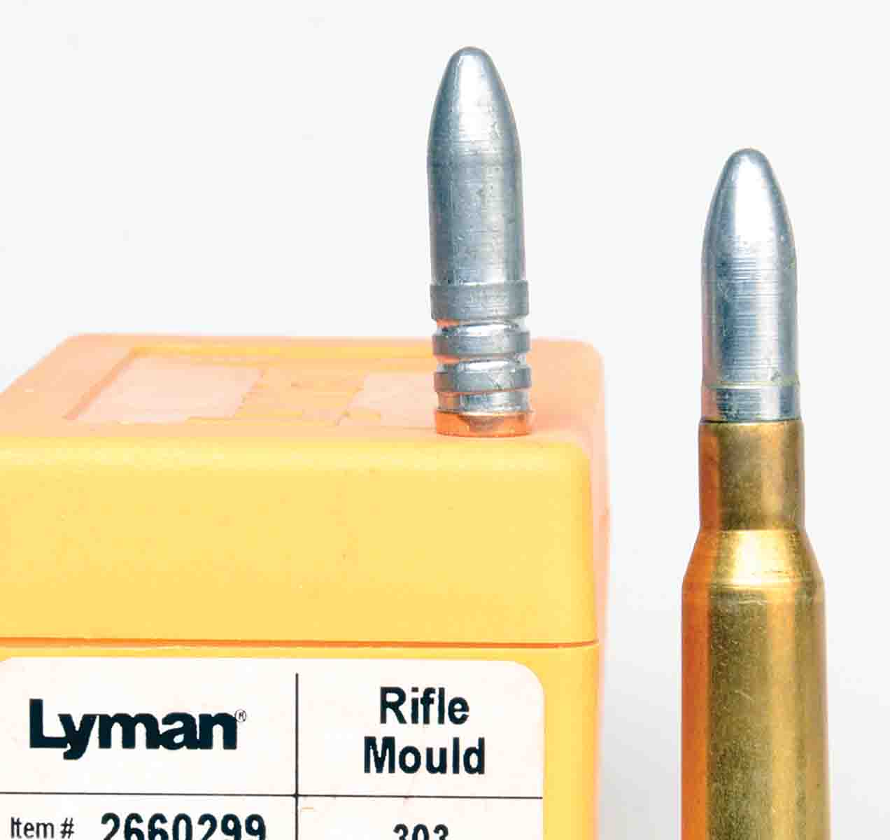 Mike considers gas checks necessary for cast bullet shooting with bottlenecked, smokeless-powder rifle cartridges, such as the 7.62x54R, but they must be applied properly. The bullet on the mould box is leaning because its gas check is not seated properly.
